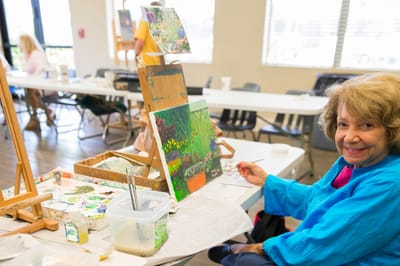 Resident painting during an activity session