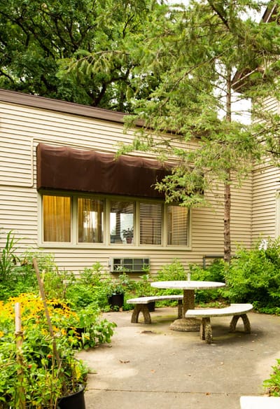 Cozy outdoor seating area with greenery and flowers