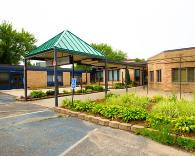 Exterior view of a senior living facility with landscaping
