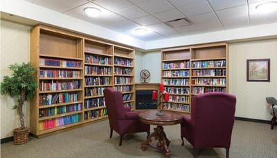 Cozy reading nook with bookshelves and armchairs