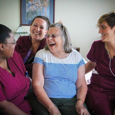 Care staff and a resident sharing a joyful moment