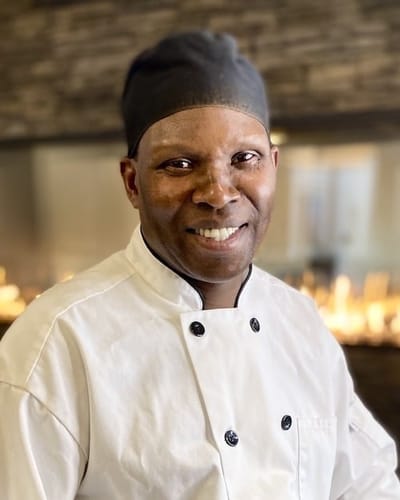 Chef smiling in a kitchen environment