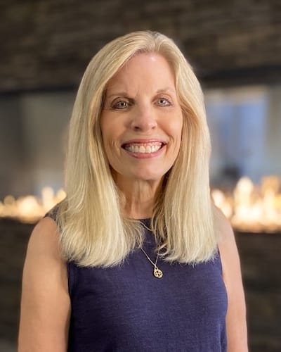 A smiling woman in a senior living facility setting