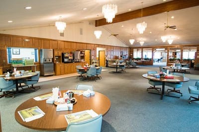 Interior dining area with residents seated at tables