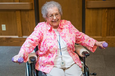 Resident participating in a strength exercise in a common area