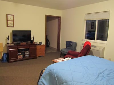 Private resident room with furniture and TV