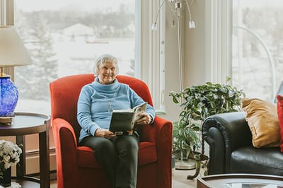 Resident reading in a cozy common area.