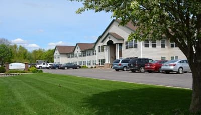 Vista Prairie At Ridgeway On G, assisted living in New Ulm, MN — Senior living facility exterior with landscaped lawn and parking