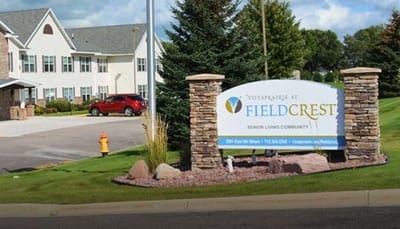 Vista Prairie At Ridgeway On G, assisted living in New Ulm, MN — Sign for senior living community with landscaped entrance