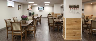 Bright dining area with wooden tables and chairs
