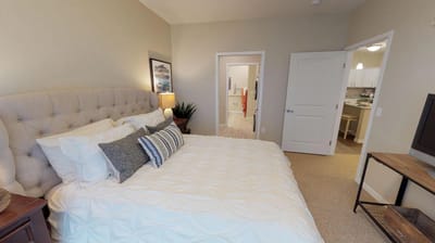 A well-furnished resident room with a bed and decor