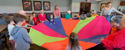 Residents and children engaging in a colorful group activity