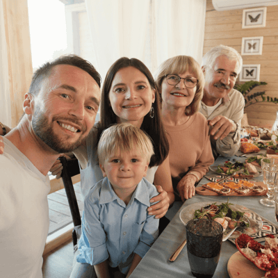 Group of residents and family enjoying a meal together