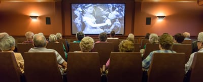 Residents watching a movie in a theater room