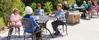 Residents enjoying a sunny day outdoors at a social gathering