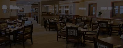 Dining area with tables and chairs in a well-lit room