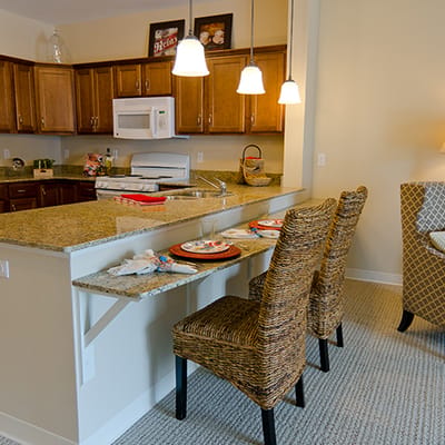 Bright kitchen area with bar seating and decor