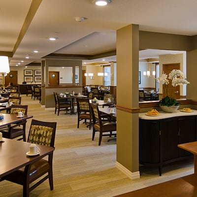 Dining area with tables and chairs in a brightly lit room