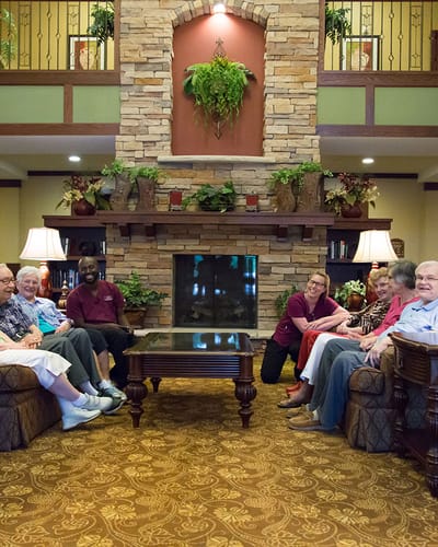 Residents and staff relaxing in a cozy common area