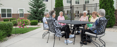 Residents conversing in an outdoor seating area