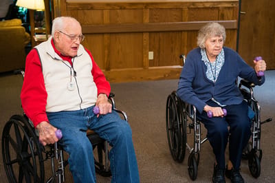Residents exercising with weights in a common area