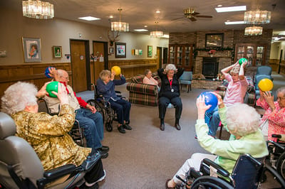 Residents participating in a seated exercise class