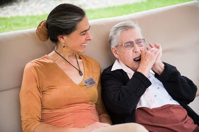 Resident and staff member enjoying time outdoors together