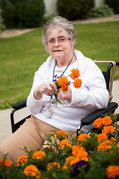 Resident enjoying flowers in the garden