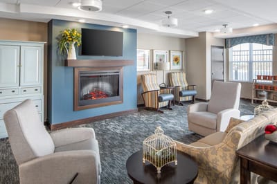 Bright and inviting common area with seating and a fireplace