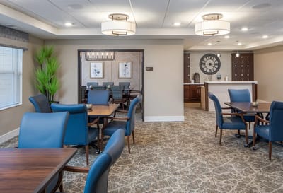 Bright common area with dining tables and seating