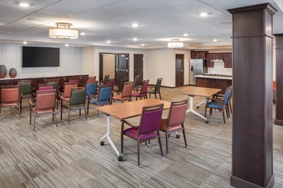 Bright common area with seating and a kitchen
