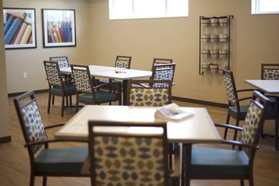 Interior activity room with tables and chairs