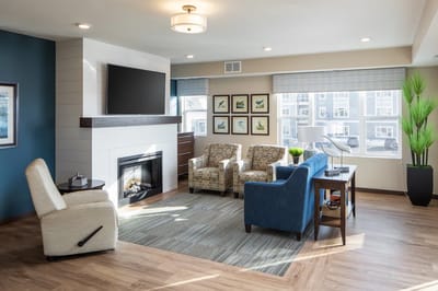 Bright common area with seating and fireplace