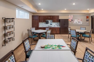 Bright activity room with tables and supplies