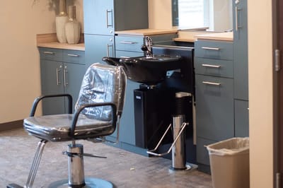 Hair salon area with a chair and sink