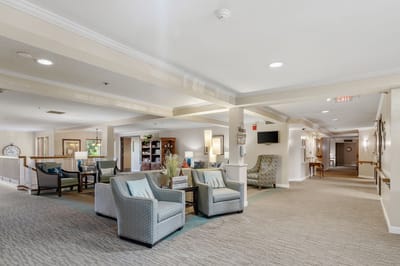 Common area with seating and bookshelves in a nursing home