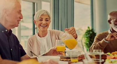 Residents enjoying a meal together with drinks