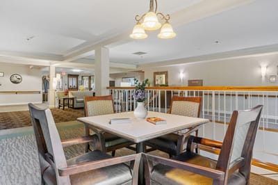 Common area with tables and chairs in a bright lobby