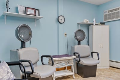 Hair salon chairs in a light blue room
