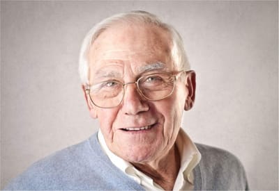 Portrait of a smiling elderly man with glasses