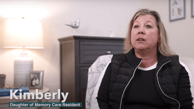 Daughter of a memory care resident speaking in a cozy room