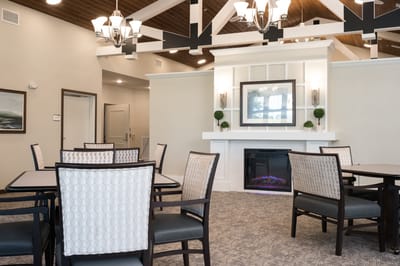 Bright common area with seating and a fireplace
