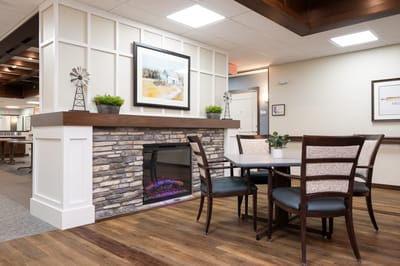 Interior common area with a fireplace and seating