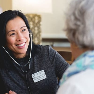 Nurse interacting with a resident in a warm setting
