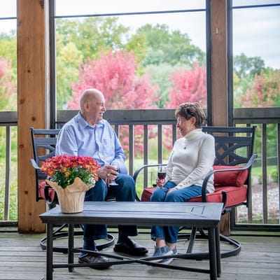 Residents enjoying conversation on a screened porch