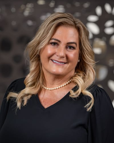 A staff member smiling in a professional setting