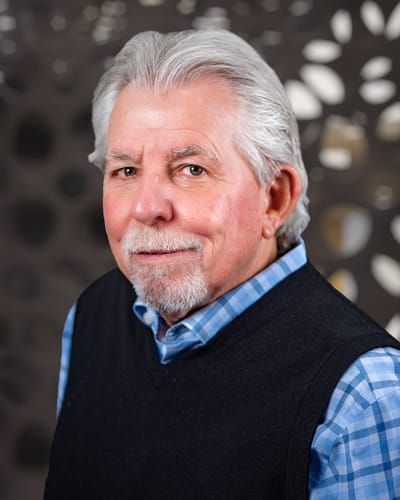 Close-up portrait of a senior man in an interior setting