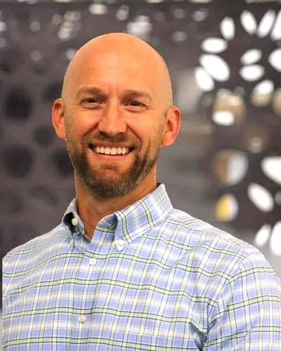 Smiling man in a checkered shirt