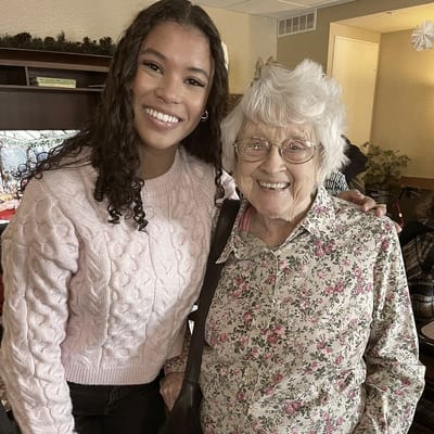 Staff member with a resident inside the facility