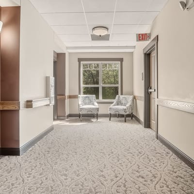 Bright hallway with comfortable seating in an assisted living facility